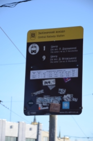 Signboard at tram stop outside Lviv's railway station, indicating that both trains 1 and 9 reach the city centre